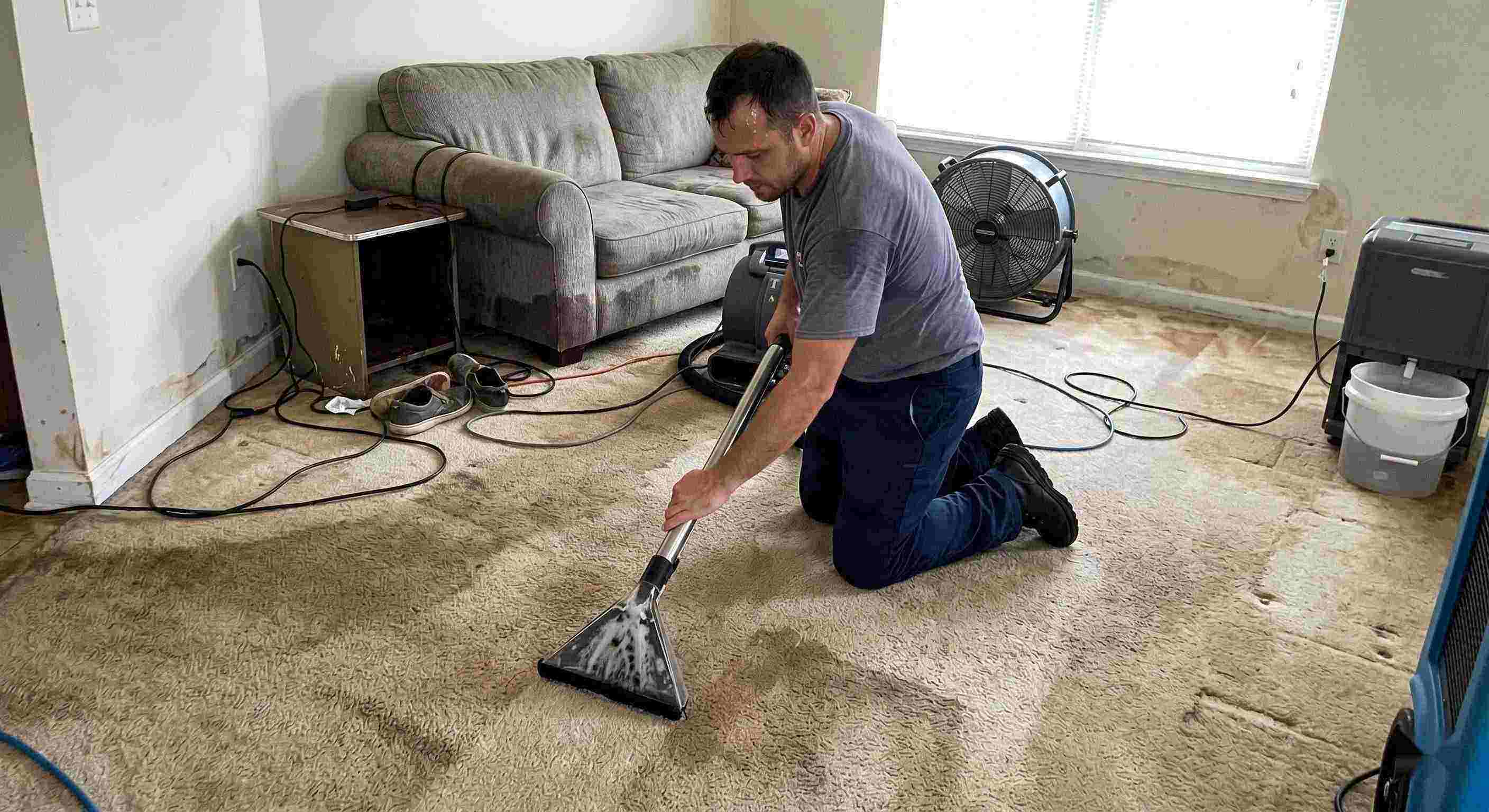 Fast technician performing carpet water extraction in a residential home using professional equipment after water damage in Fairfield